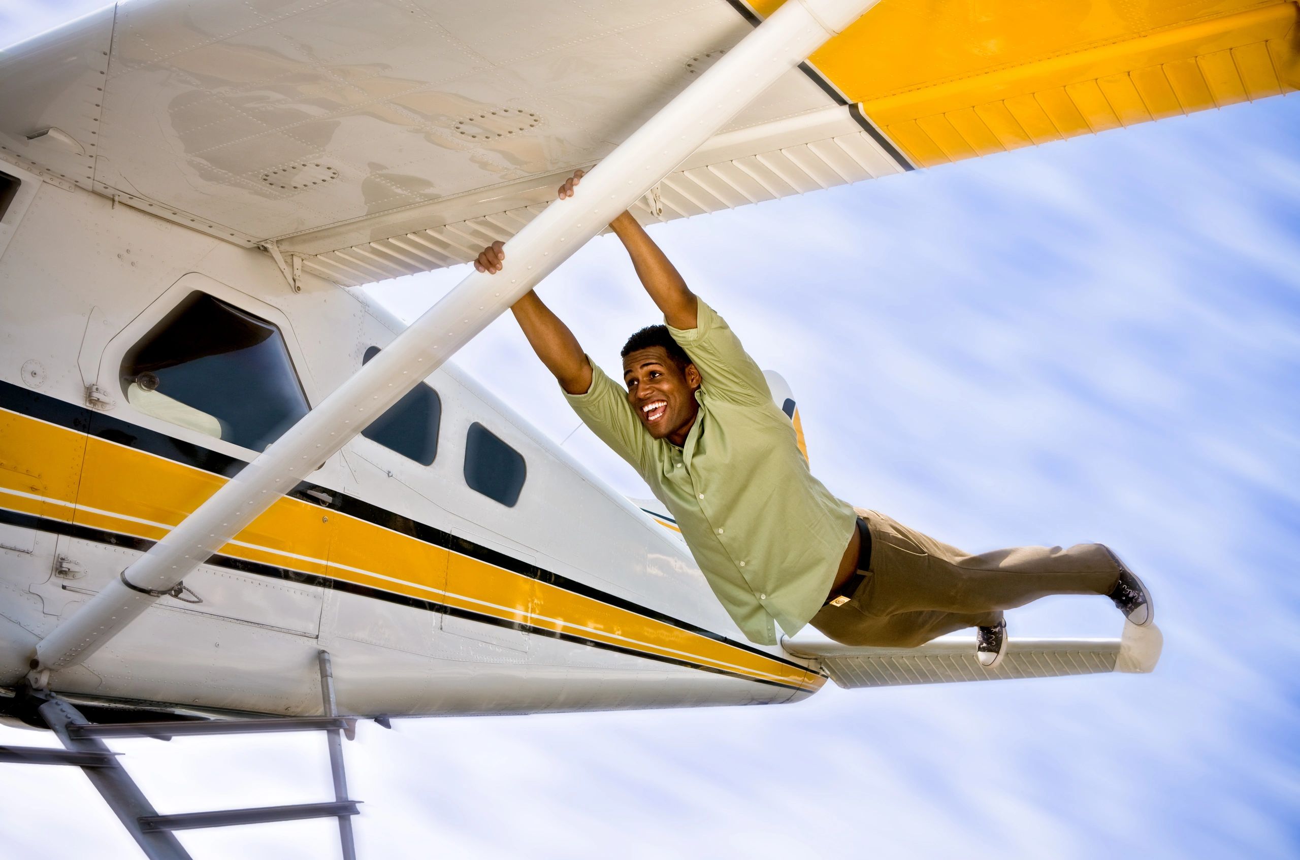 Pilot smiling beside a small airplane